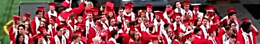 Seniors with red cap and gown at graduation