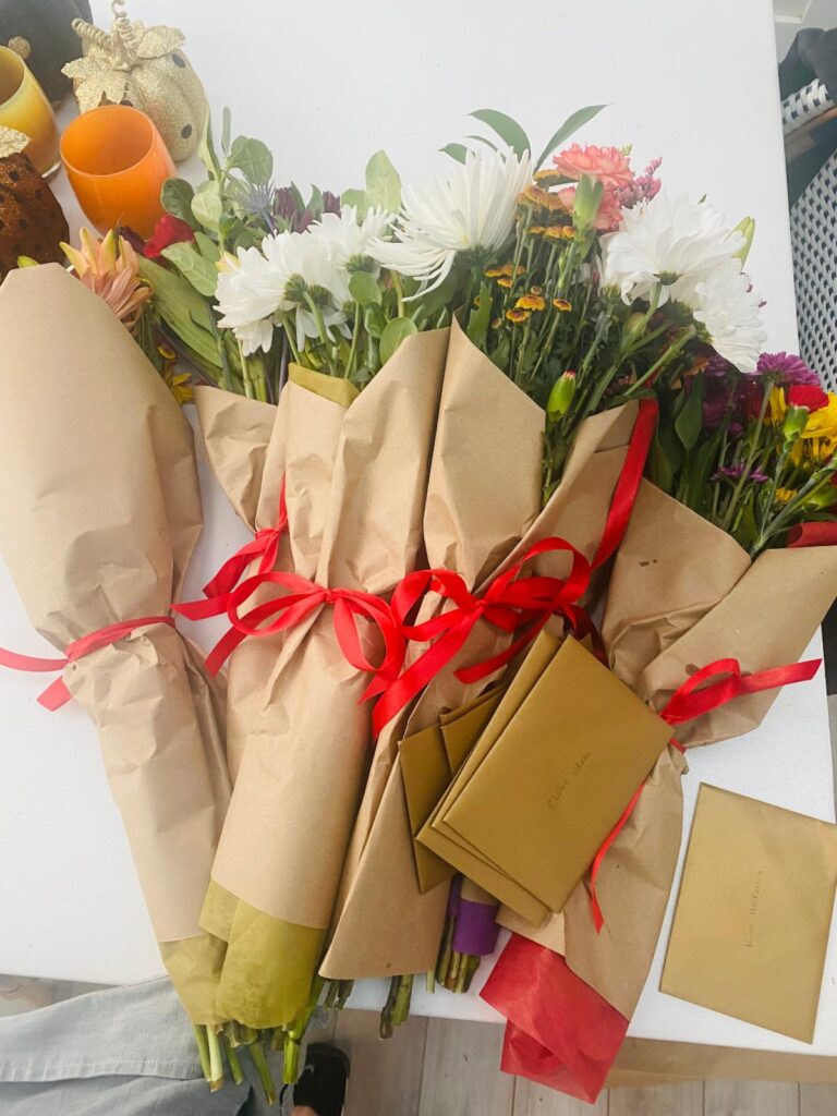 Bunches of Flowers wrapped in parchment paper on a desk