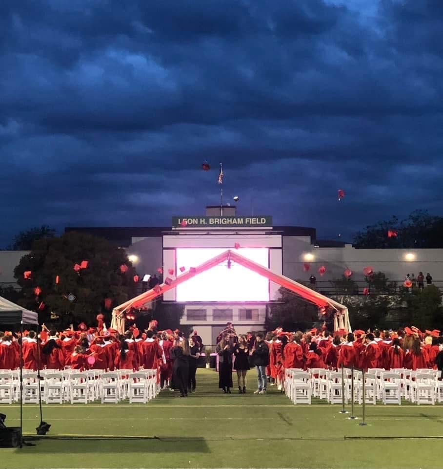 Memorial Stadium Graduation Caps in the air
