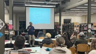 Speaker Greg Smith in BHS Library with parents at tables